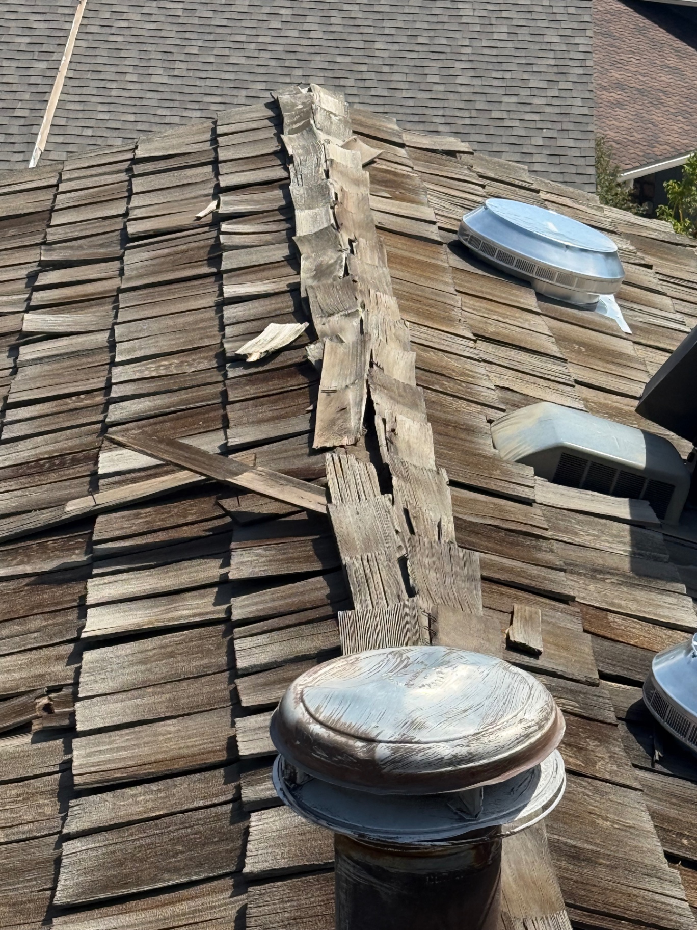Weathered cedar ridge and roof vent detail on Centennial roof
