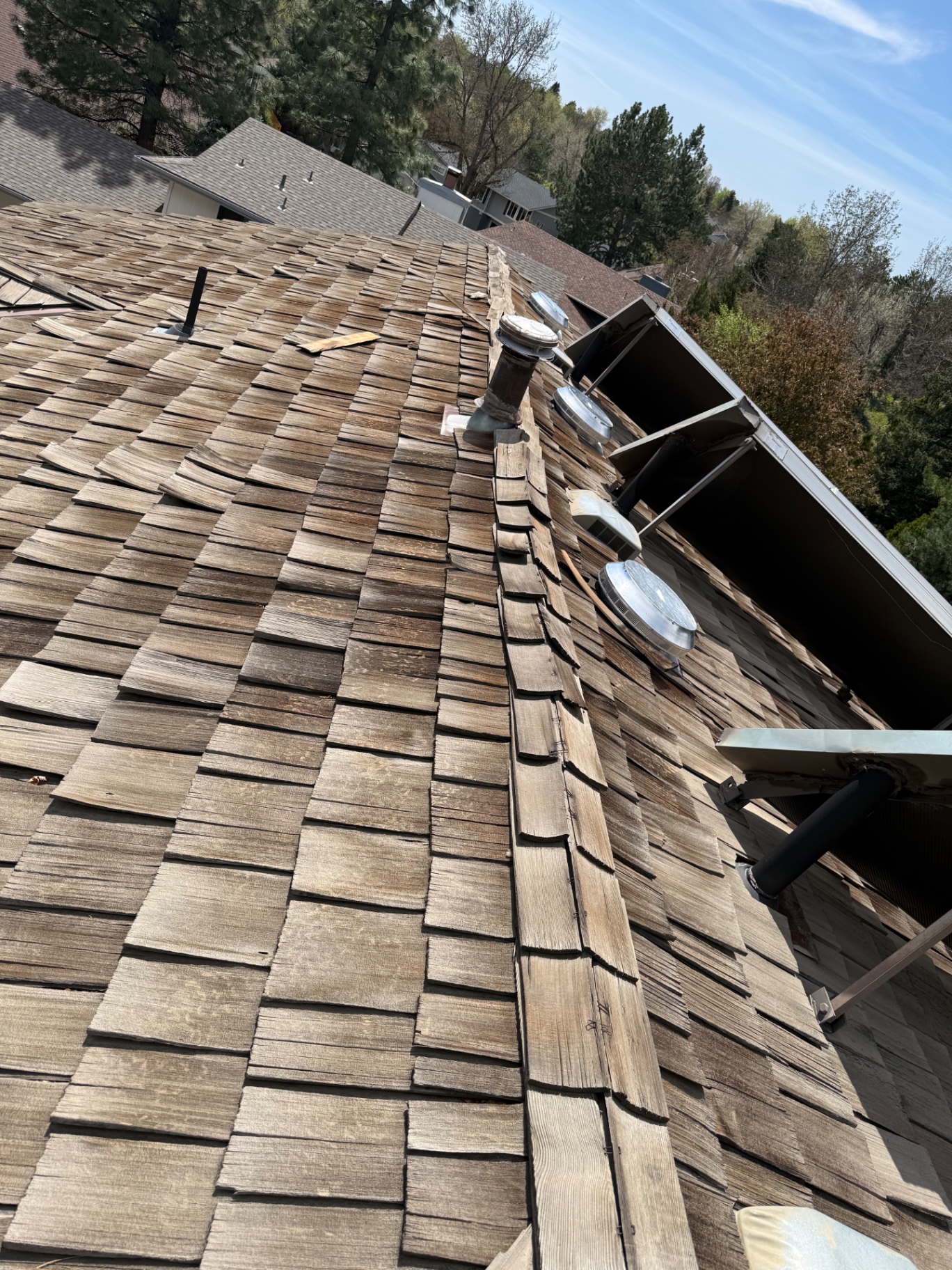Overview of weathered cedar shake roof on Centennial home