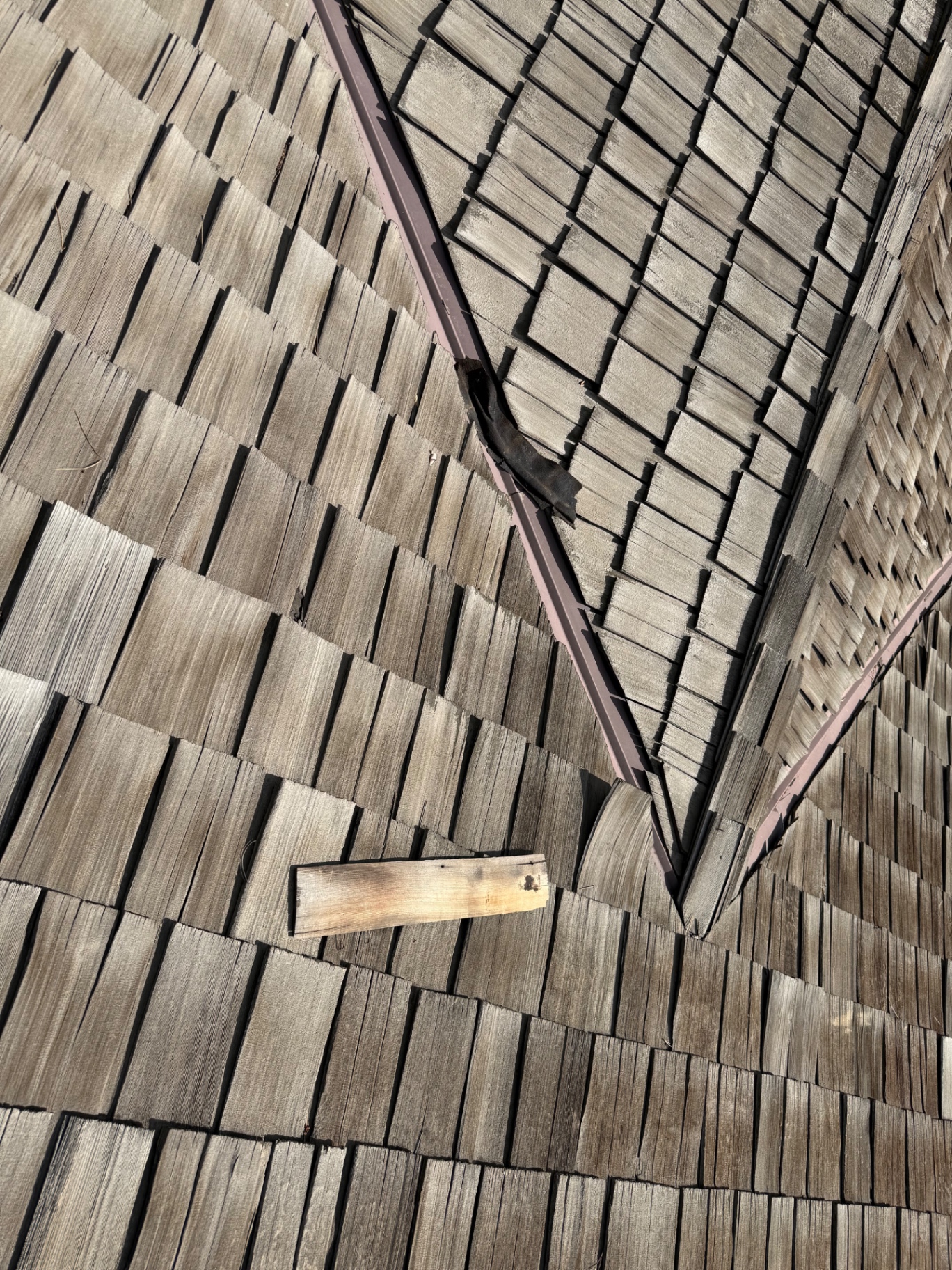 Cedar shake valley detail showing deterioration on Centennial roof