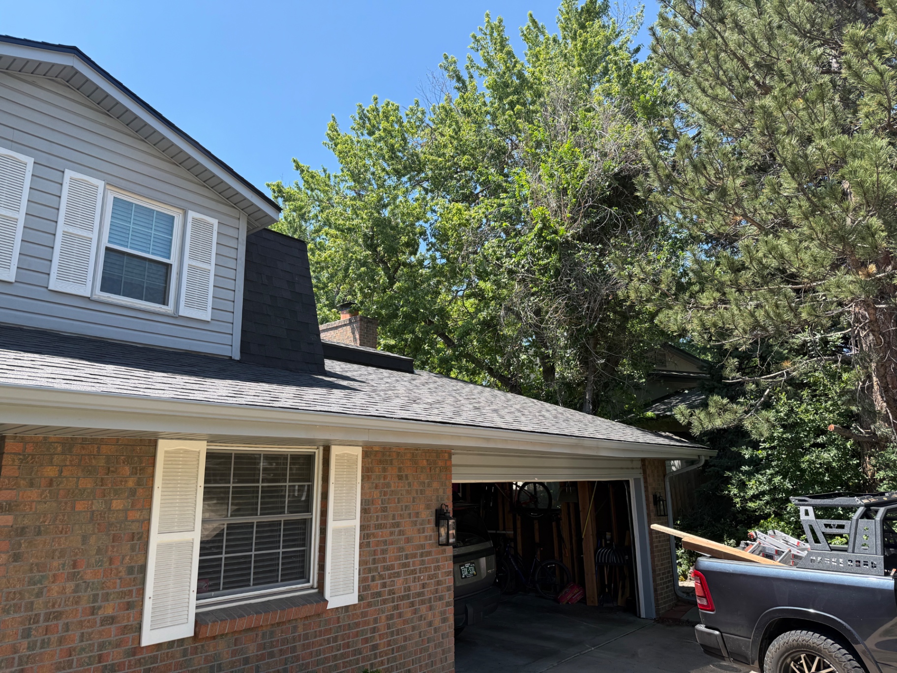 New shingles over garage and side roof on Centennial home